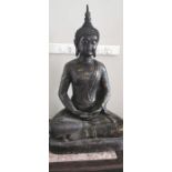 A decorative gilt metal figure of a seated buddha