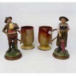 German figures of a man drinking and woman with umbrella along with two ceramic tankards