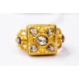 A diamond set ring, comprising ethnic decoration, 18ct gold, square mount set with rose cut diamonds