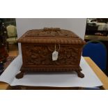 A 19th Century carved wooden table casket, on paw feet