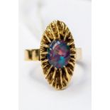 An opal set 18ct gold dress ring, circa 1970's, fancy mount set to the centre with an oval opal