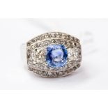 A  sapphire and diamond cluster ring, the cushion cut sapphire weighing approx 2.29 carats,