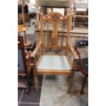 An early 20th Century carved oak Hall chair on squared carved supports