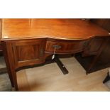 An Edwardian mahogany inlaid sideboard with one central drawer and two small cupboards, raised on