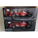 A pair of Hot Wheels models: Ferrari 1:18 scale; F2003-8A Michael Schumacher and Canadian Grand Prix