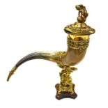 A 19th Century ceremonial sporting trophy hunting horn, brass cover and mounts, on an oak plinth,