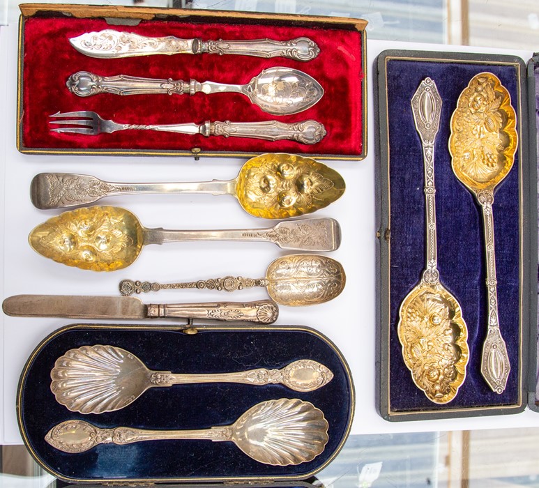 A pair of Edward VII silver fruit spoons in case; a pair of Victorian berry spoons; a pair of