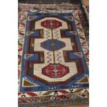 A late 20th Century decorative rug, with a matching pair of red Persian style rugs.
