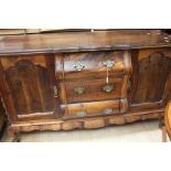 An early 19th century reproduction Dutch sideboard with crow's ball and claw feet and brass ring