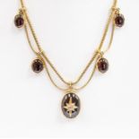 A Victorian garnet swag necklace, comprising five drops, the central drop with an oval cabochon
