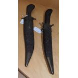 A pair of Indian carving knives and forks, in carved sheaths (2)