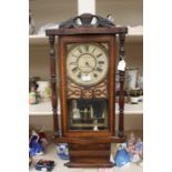 A late 19th Century American style wall clock, scroll and inlay design, retailed in Loughborough