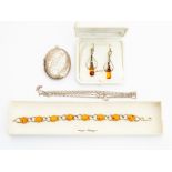 A collection of silver and white metal jewellery to include amber drop earrings, an amber set