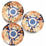 A set of three 19th Century Chinese plates, decorated in the imari palette with baskets, foliage and