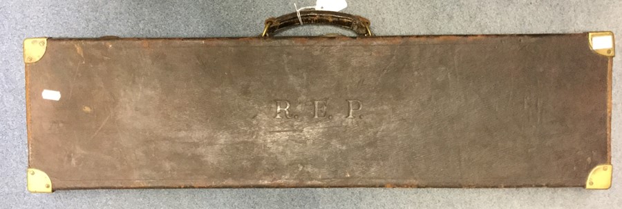 A leather gun case. No makers label present. 83cm x 22cm. Initials "REP" embossed to lid. Brass