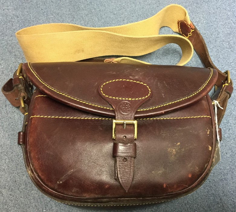 A leather cartridge bag by William Evans Gun & Rifle Makers. Complete with canvas web sling.