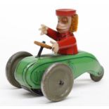 Schuco: A circa 1930's Schuco, tinplate monkey seated on three-wheel scooter, ginger plush hair,