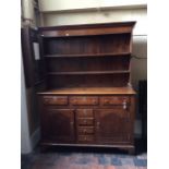 A George III oak dresser, circa 1770, the original plate rack with a moulded projecting cornice over