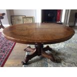 An early Victorian pollard oak inlaid oval breakfast table, circa 1850, supported on turned flute