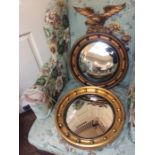 A late 19th Century giltwood circular framed wall mirror and similar Regency style circular framed