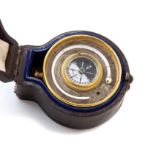 A late 19th Century brass travelling pocket barometer/thermometer and compass combined, in the