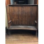 A George III elm and pine curved settle, circa 1810, elm frame with pine panels,