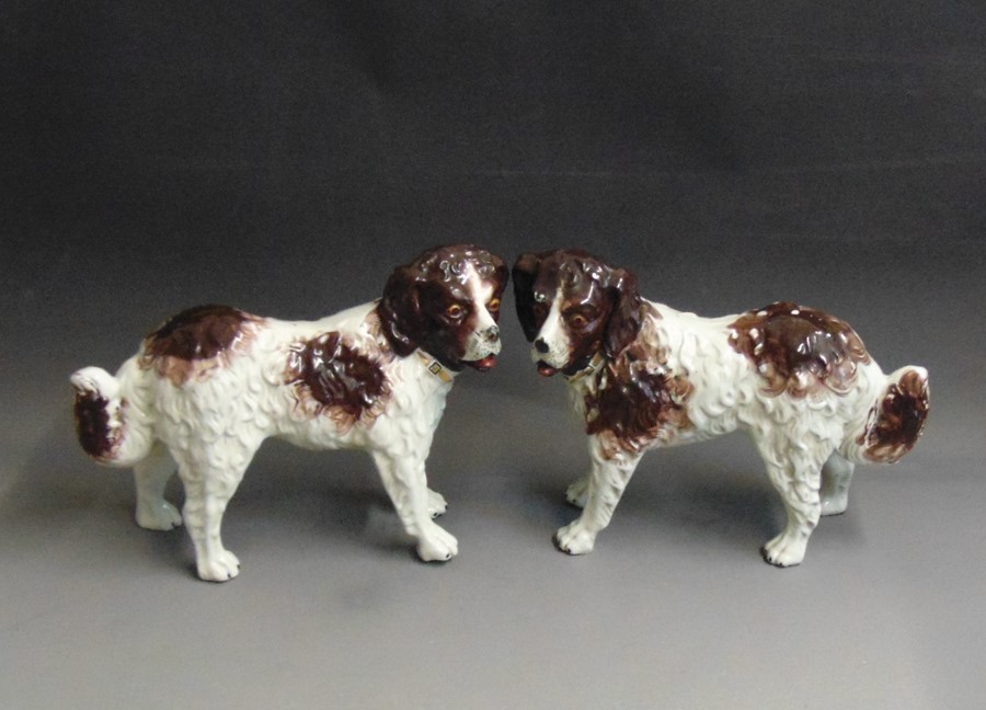 A pair of Staffordshire St Bernard dogs painted in russet and brown,  circa 1860, 35cm high, 24cm