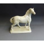 A Leeds Pottery ‘Revivalist’ creamware  model of a horse, standing four square on an oblong base