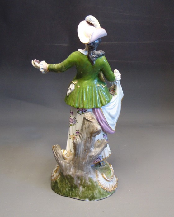 A Continental figure  of a lady flower seller, she standing with flowers in her heft hand and - Image 2 of 3