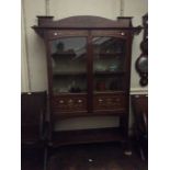 An Edwardian Art Nouveau display cabinet, in the manner of Shapland and Petter, fitted with two