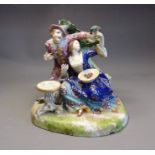 A Samson of Paris porcelain group of a couple feeding a parrot, late 19th Century, faux red Derby