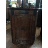 A George III mahogany hanging corner cupboard, fitted with a single door, 108cm high