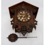 A 19th Century Black Forest cuckoo clock, the case pierced and fret cut in "Gothic" style, the