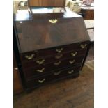 A George III mahogany bureau, the fall front enclosing a fitted interior, with drawers and pigeon