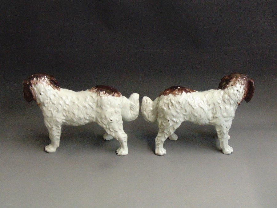 A pair of Staffordshire St Bernard dogs painted in russet and brown,  circa 1860, 35cm high, 24cm - Image 2 of 2