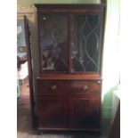 A George III mahogany secretaire bookcase, blind fretwork top, fitted with two glazed doors enclsing