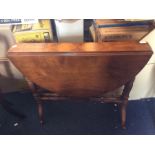 A Victorian walnut sutherland table, circa 1880, oval dropleaf top raised turned supports on brown