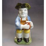 A Prattware toby jug, decorated underglaze colours, early 19th Century, 22cm high Condition: hat