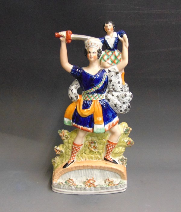 A Staffordshire figure of ‘Rolla’ standing on a bridge holding a  child on his shoulder and a sword