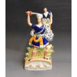 A Staffordshire figure of ‘Rolla’ standing on a bridge holding a  child on his shoulder and a sword