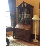 An 18th century mahogany glazed bookcase bureau, circa 1770, in the manner of Chippendale, crowned