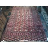 A traditional oriental rug, all-over medallion Turkman design, 165cm by 240cm