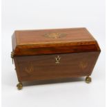 A Regency mahogany tea caddy. circa 1820, of sarcophagus form, the cover with central marquetry