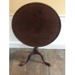 A George III mahogany tilt top table, circa 1780, support on tapered column on three cabriole feet.