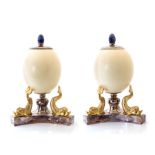 A pair of ostrich egg desk ornaments, attributed to Anthony Redmile, lapis lazuli finials, in