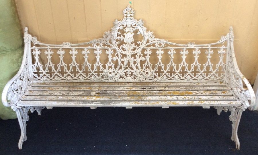 A Victorian cast iron garden bench, in the manner of Coalbrookdale, painted white, having cast