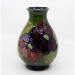 A Moorcroft hibiscus baluster vase, impressed mark and green W.M initials in script, height 22cm