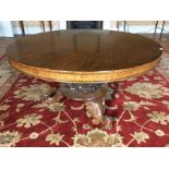 An early Victorian oak tilt top pedestal breakfast table, the circular top raised on an