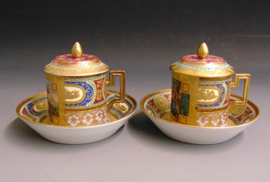 A pair of Vienna cans, saucers and covers, lavender ground, overlaid with bright enamels of blue red