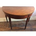 A George III mahogany and satinwood inlay folding demi lune tea table, circa 1780, raised on tapered